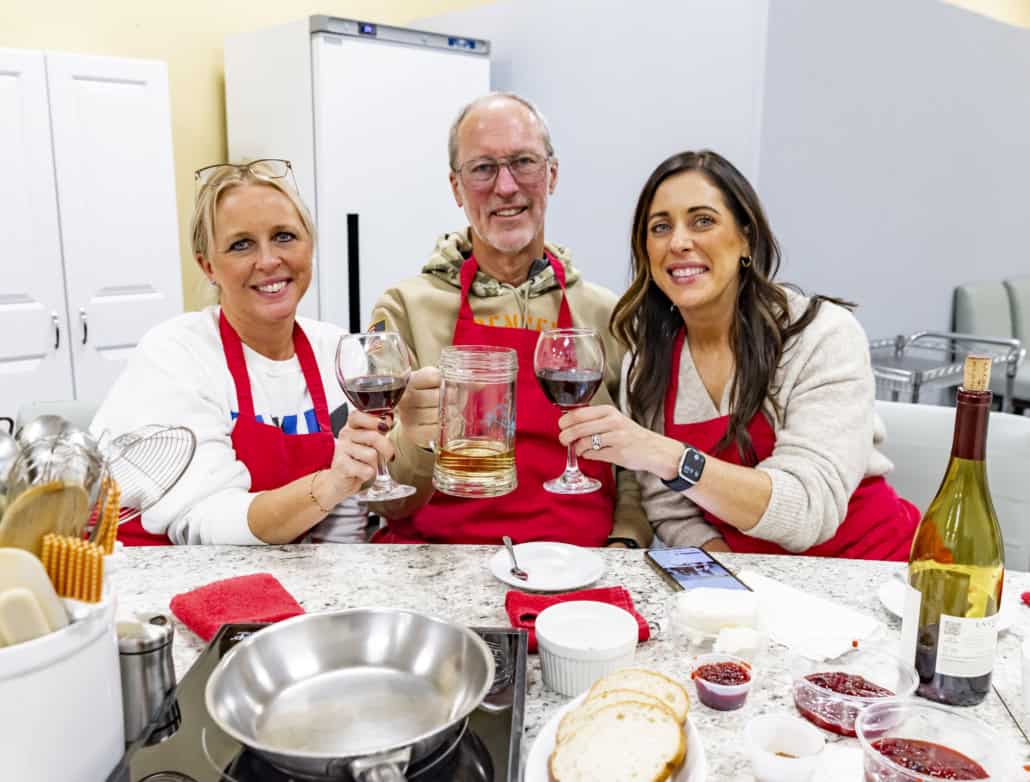 family at cooking class in st louis holding wine