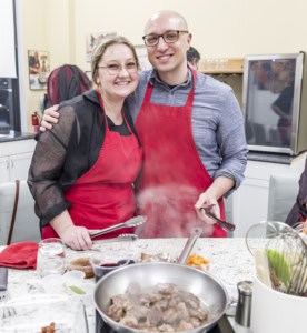 Cooking class guests preparing French dishes together